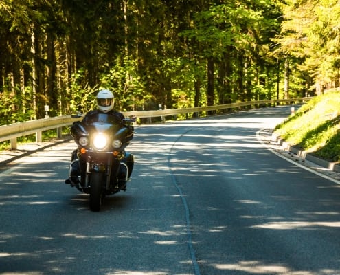 Motorcycle on the rural road in forest